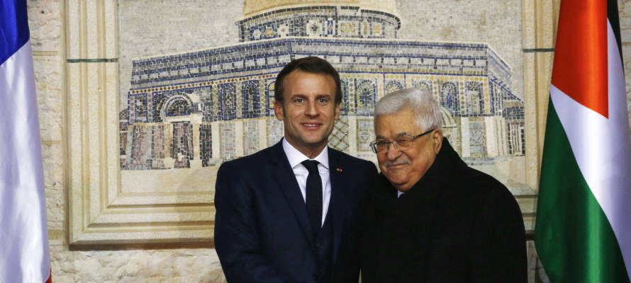 Palestinian leader Mahmoud Abbas, right, welcomes French President Emmanuel Macron