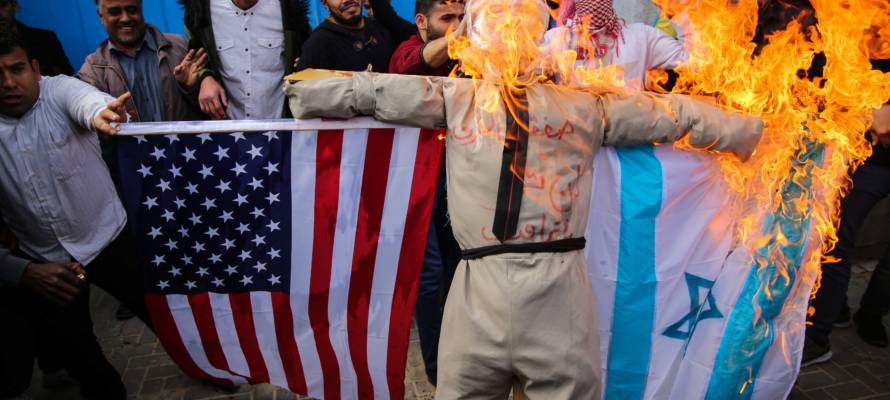 Palestinians burn an effigy of Donald Trump