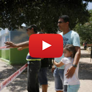 Israelis near the remains of a rocket fired by Palestinian terrorists