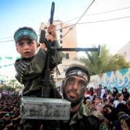 A Palestinian child holding a machine gun at a Hamas rally in the Gaza Strip