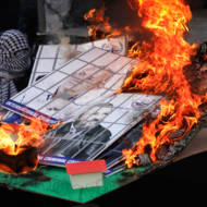 Fatah supporters burn a model of an Israeli Jewish community and images of Israeli political leaders during a rally to celebrate the 55th anniversary of the founding of the Fatah movement, in Shechem (Nablus), on January 6, 2020.