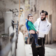 Jewish father carries his son.