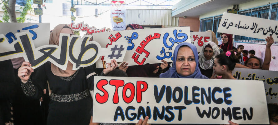 Palestinian women participate in the protest against violence against women