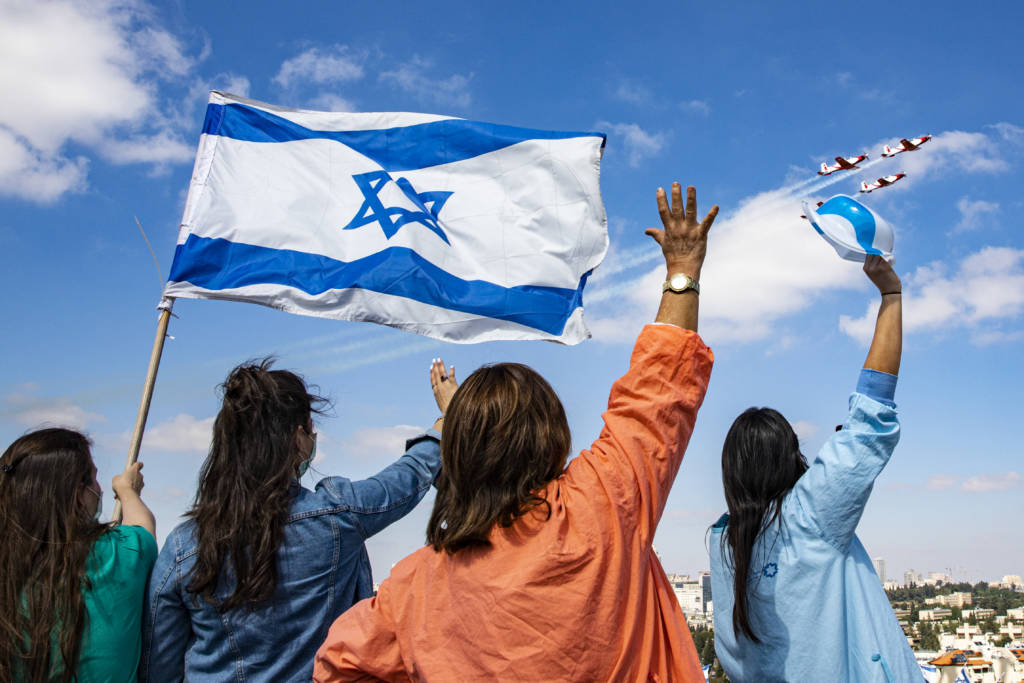 Israeli medical staff cheer an Israeli Air Force acrobatic team.