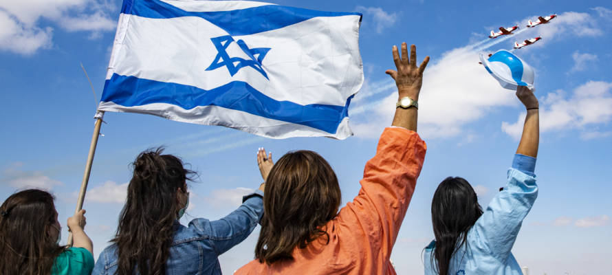 Israeli medical staff cheer an Israeli Air Force acrobatic team.