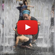 Children play in a water fountain