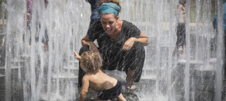 Children play in a water fountain