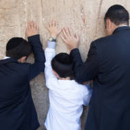 Father and sons pray Western Wall