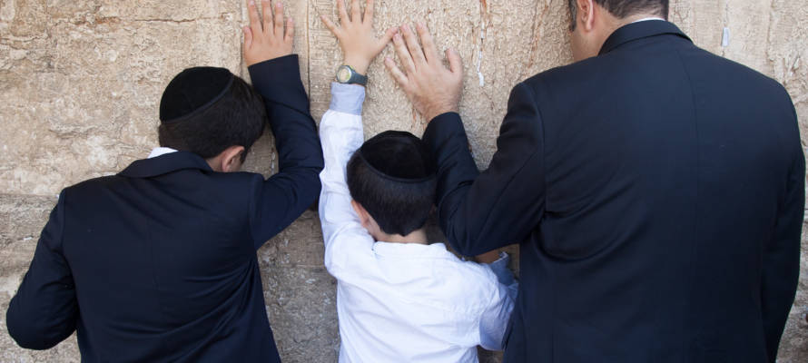 Father and sons pray Western Wall