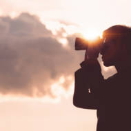 man looking through binoculars