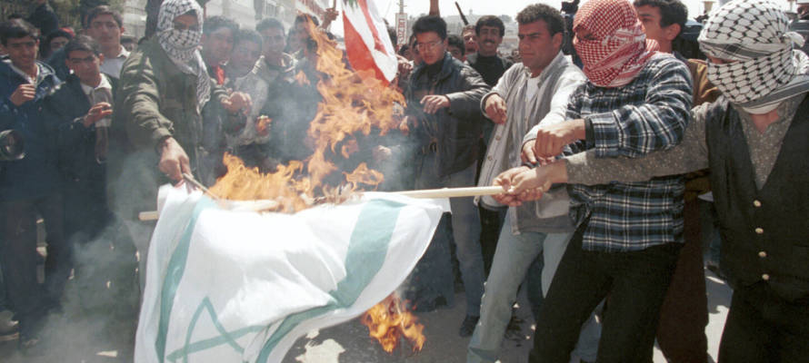 Palestinians burn the Israeli flag