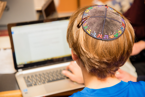 Young,Jewish,Boy,Wearing,Colorful,Hebrew,Yarmulke,From,The,Back
