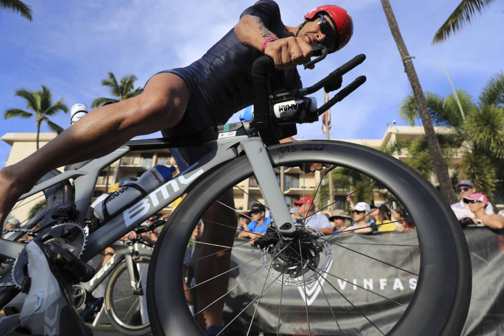 Erez Aisenberg, of Israel, jumps on his bike at the Ironman World Championship