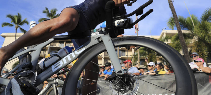 Erez Aisenberg, of Israel, jumps on his bike at the Ironman World Championship