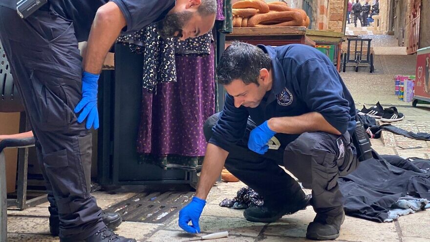 Israel Police officers investigate the scene of a terrorist attack in Jerusalem's Old City