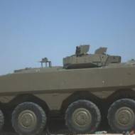 The Iron Fist active defense system mounted on an Eitan APC fires a projectile to intercept an incoming antitank missile