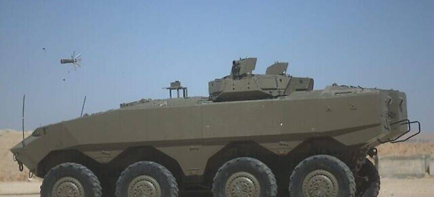 The Iron Fist active defense system mounted on an Eitan APC fires a projectile to intercept an incoming antitank missile