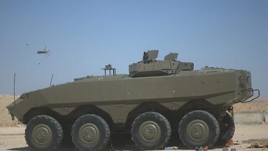 The Iron Fist active defense system mounted on an Eitan APC fires a projectile to intercept an incoming antitank missile