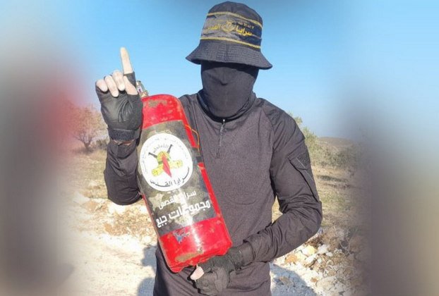 Palestinian Islamic Jihad member with a fire extinguisher rigged as an IED
