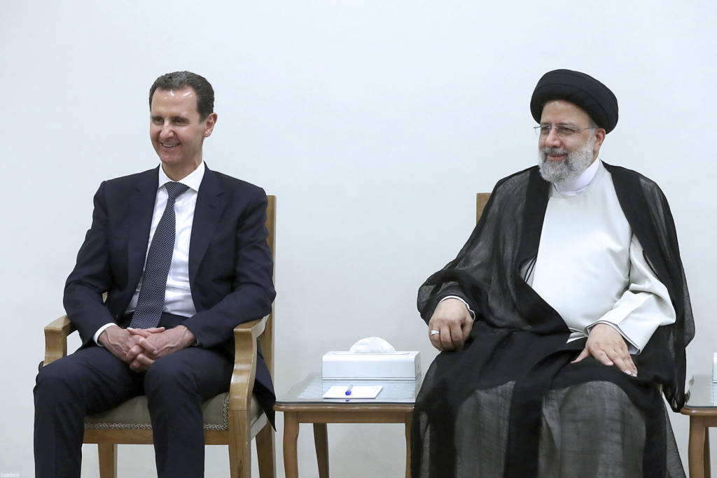 Syrian President Bashar Assad, left, and Iran's Ebrahim Raisi in Tehran