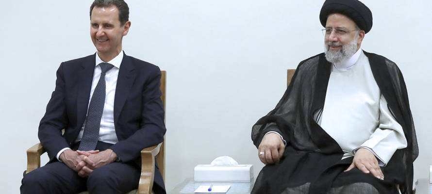 Syrian President Bashar Assad, left, and Iran's Ebrahim Raisi in Tehran