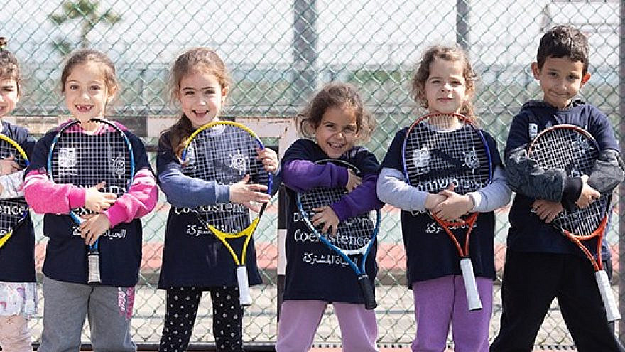 Players from the Israel Tennis & Education Centers wear coexistence-themed shirts