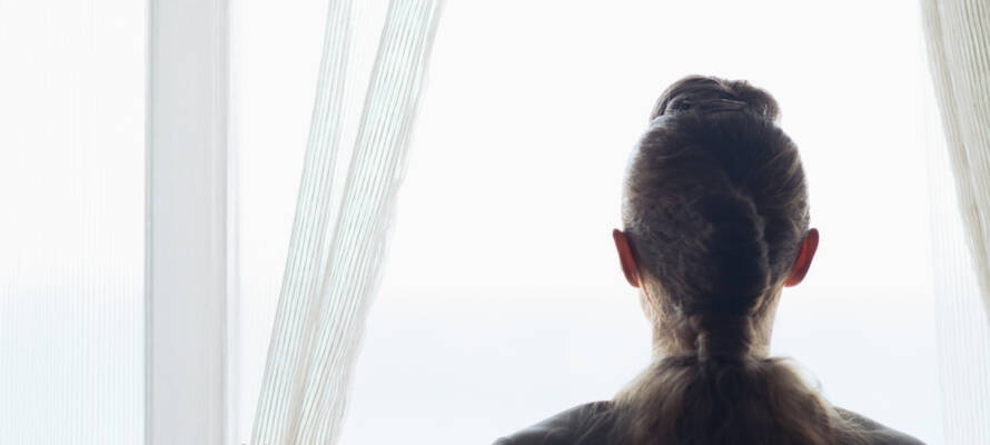 woman looking out the window