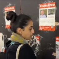 tearing down hostage posters
