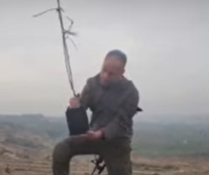 Soldier planting tree in Gaza on Tu Beshvat