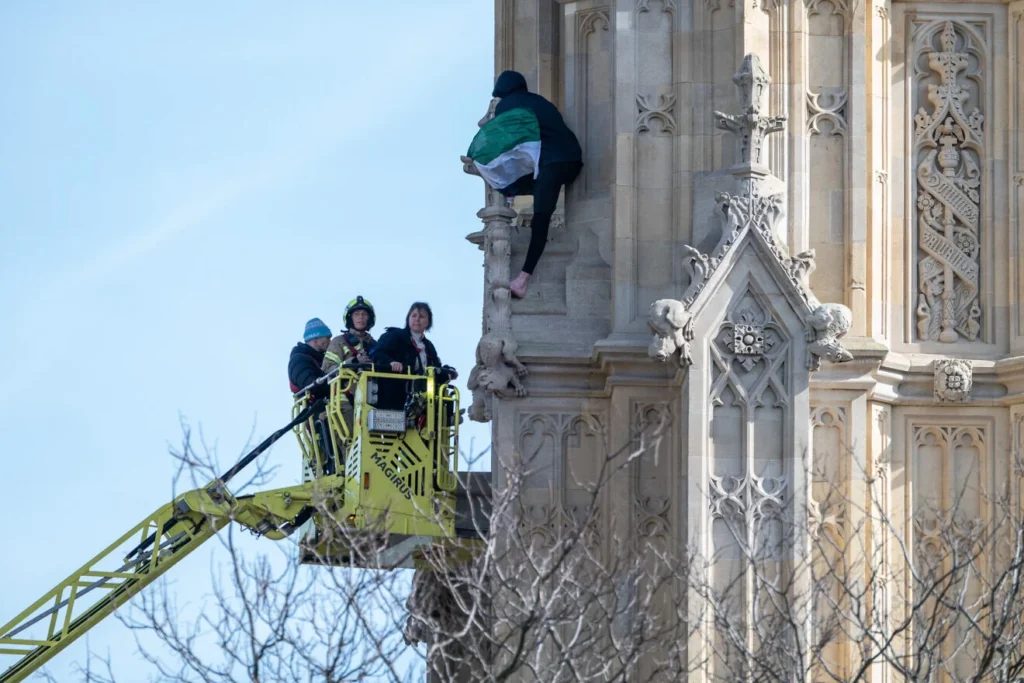 Man protesting for "Palestine" on the side of Big Ben