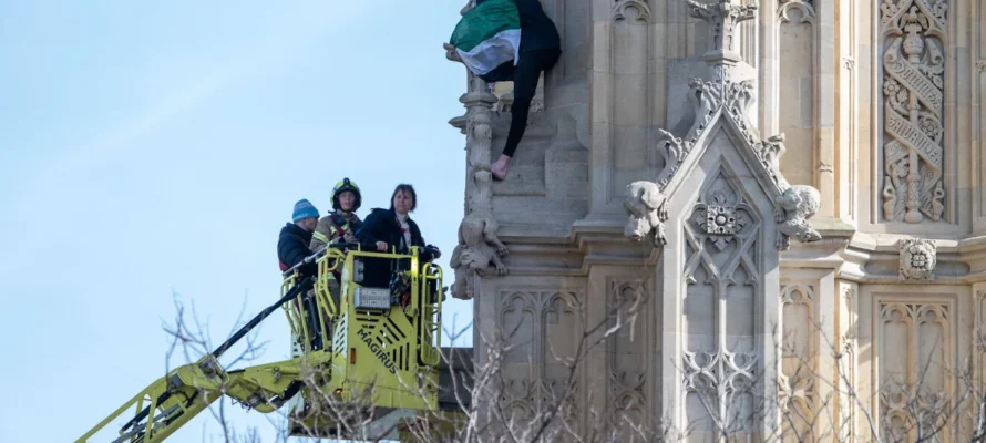 Man protesting for "Palestine" on the side of Big Ben