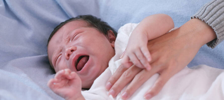 sick newborn crying