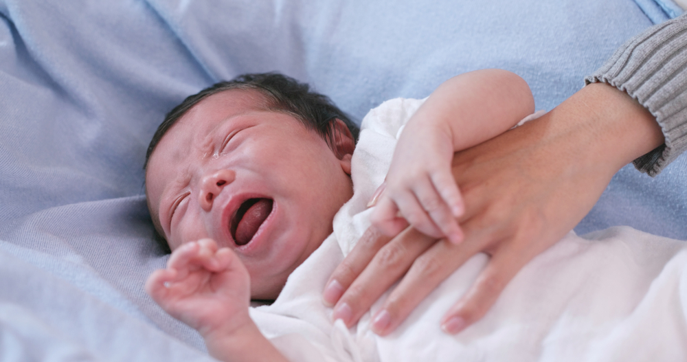 sick newborn crying