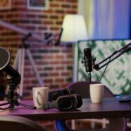 Closeup of headphones and professional microphone on empty vlogger desk